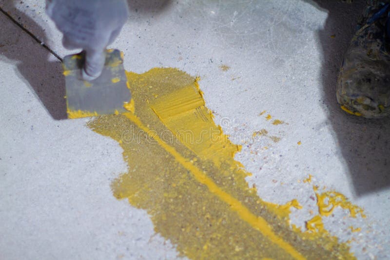 Professional is Skillfully Filling the Expansion Joints with Epoxy