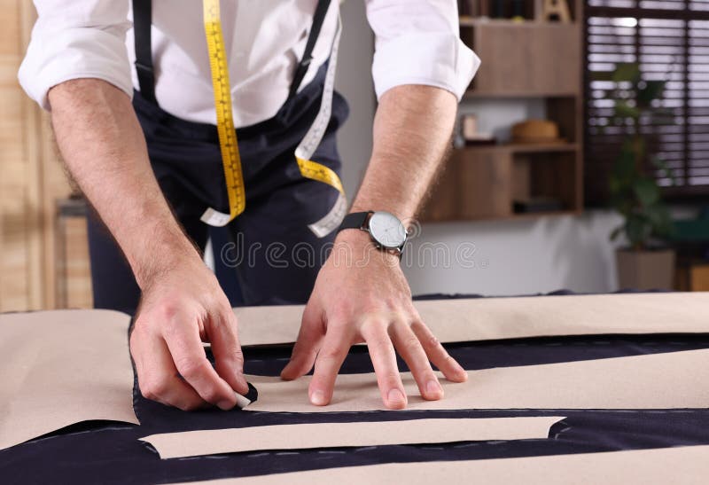 Professional Tailor Marking Sewing Pattern on Fabric with Chalk at