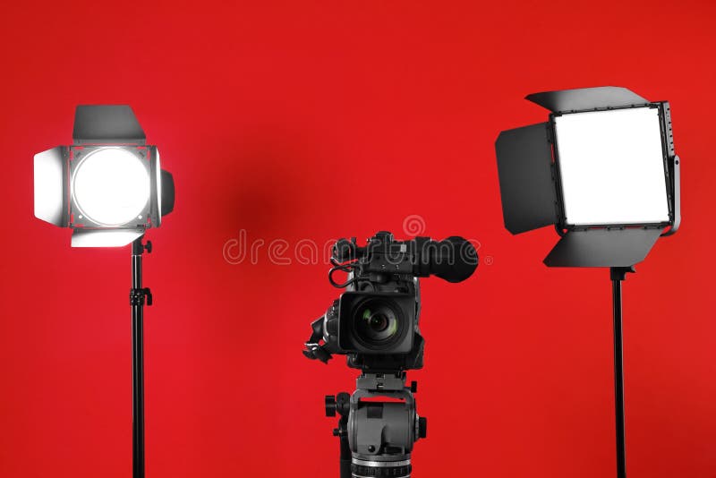 Professional Video Camera and Lighting Equipment on Red Stock Photo ...