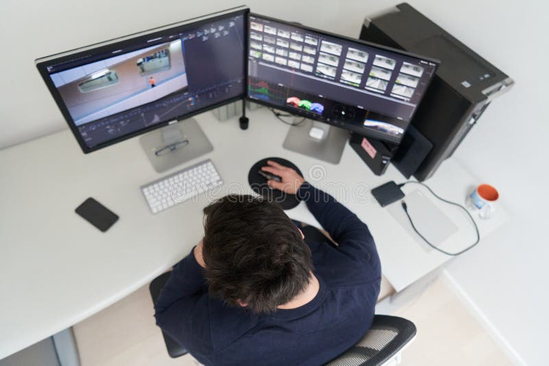 Professional video editor enhancing digital footage using specialized software royalty free stock photos