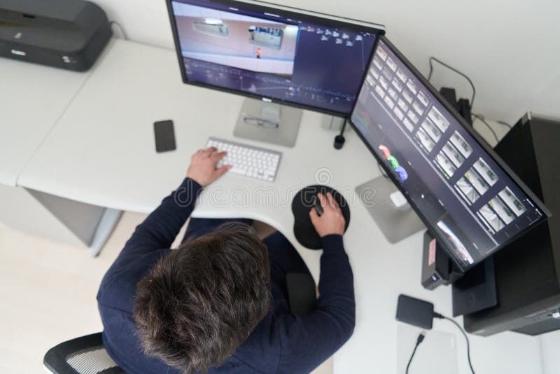 Professional video editor enhancing digital footage using specialized software stock images
