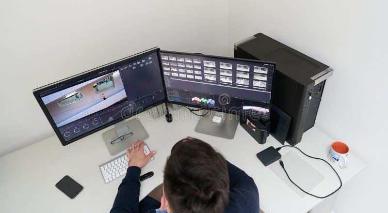 Professional video editor enhancing digital footage using specialized software royalty free stock photography