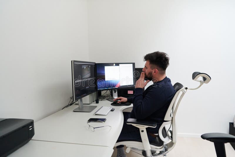 Professional video editor enhancing digital footage using specialized software stock photos