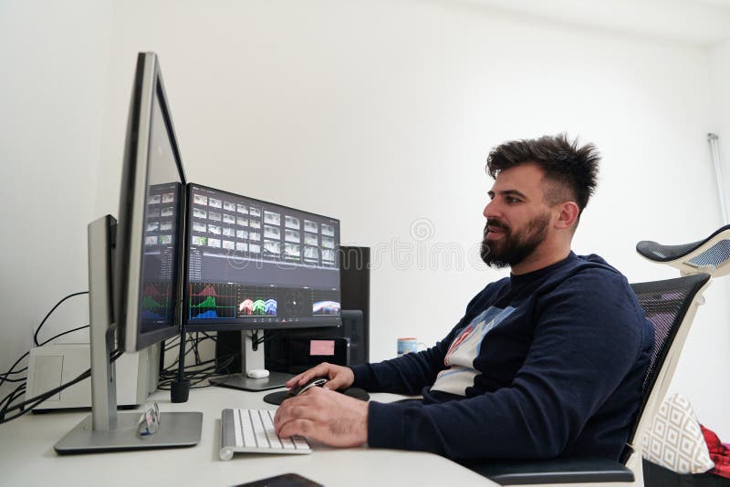 Professional video editor enhancing digital footage using specialized software royalty free stock image