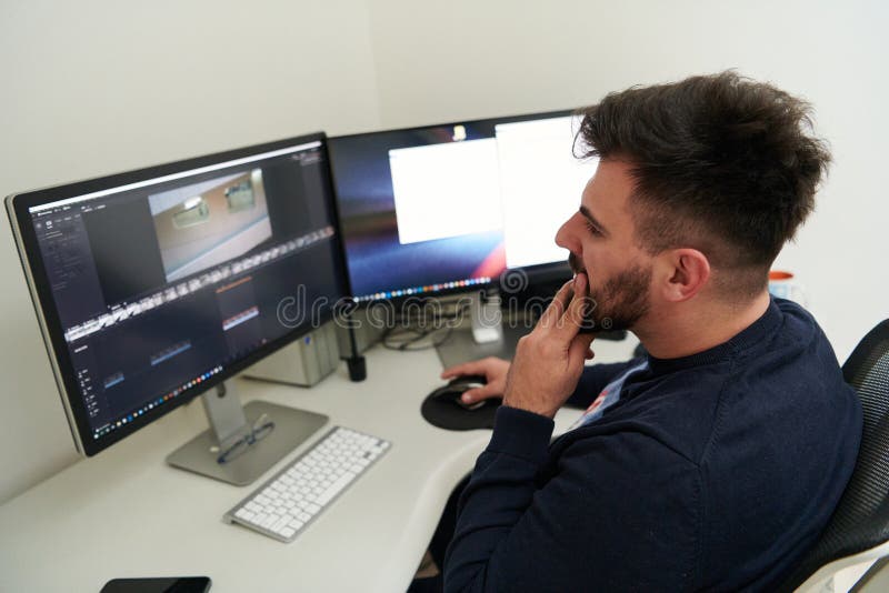 Professional video editor enhancing digital footage using specialized software stock photos