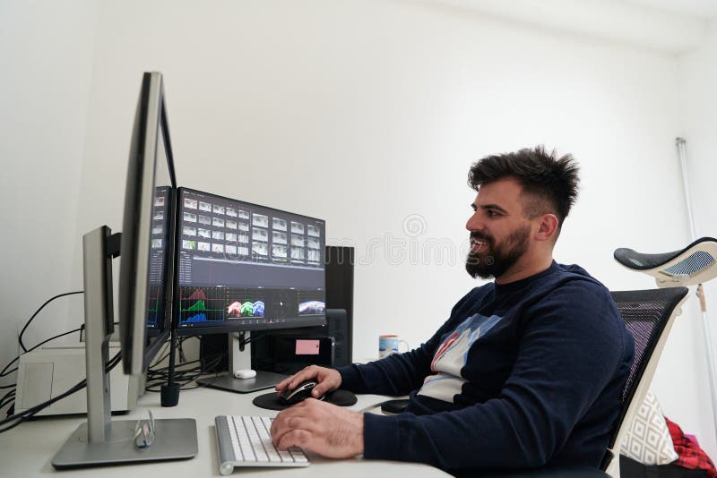 Professional video editor enhancing digital footage using specialized software royalty free stock image