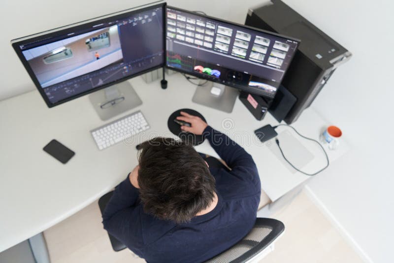 Professional video editor enhancing digital footage using specialized software stock photo