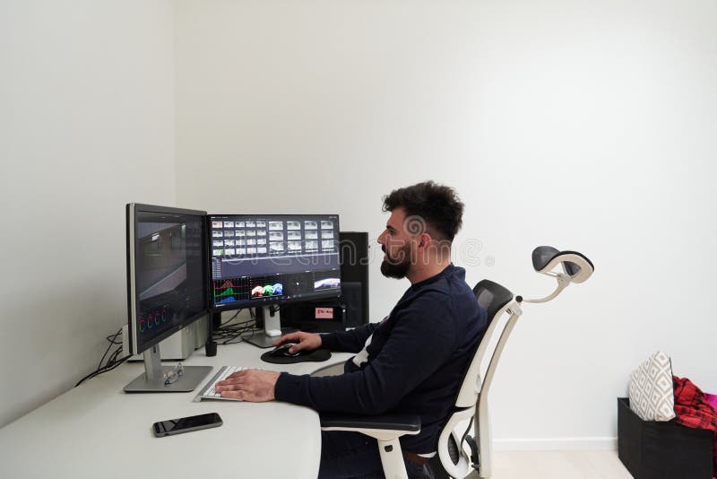 Professional video editor enhancing digital footage using specialized software stock photos