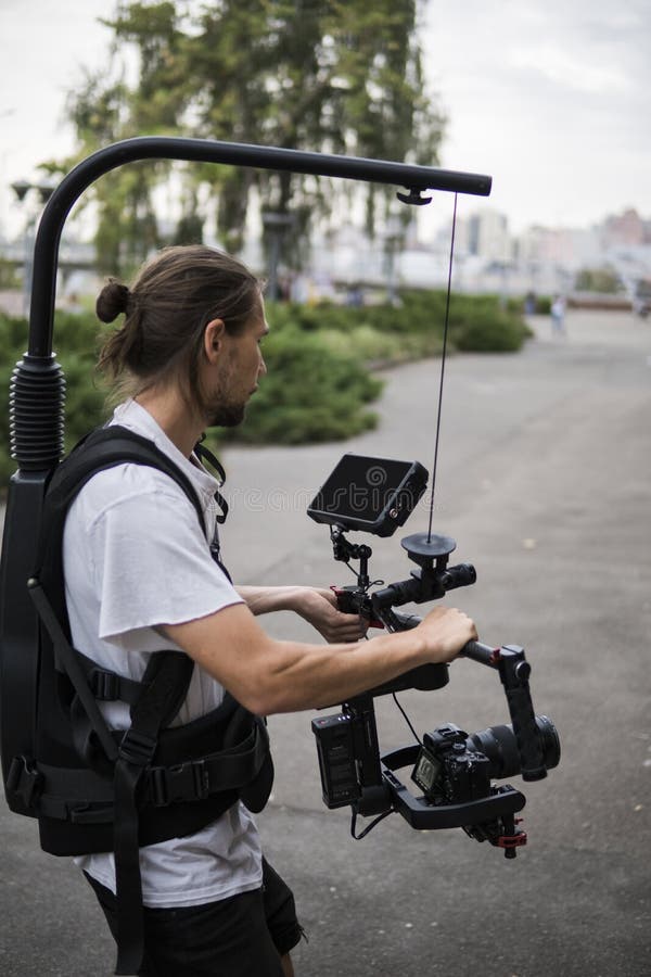 Professional Videographer Holding Camera on 3axis Gimbal Which Mounted on Easy Rig