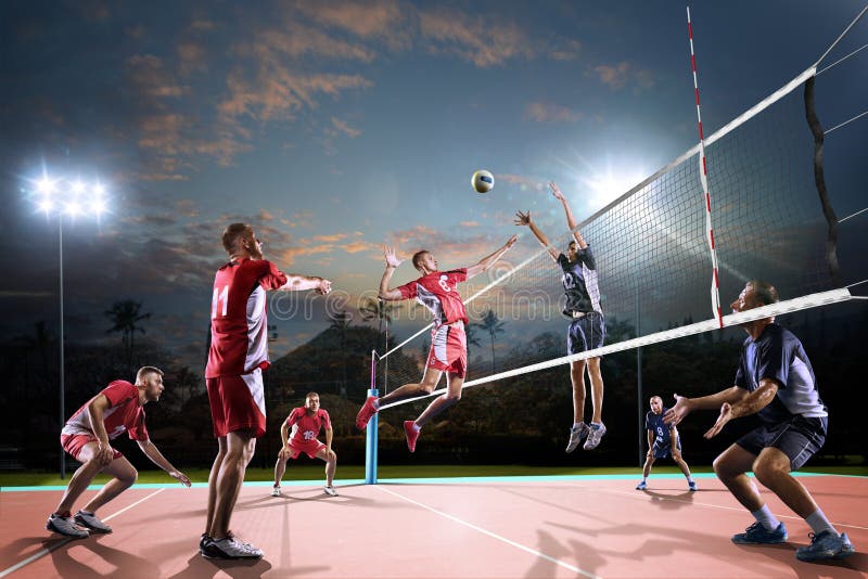 Professional volleyball players in action on the night court