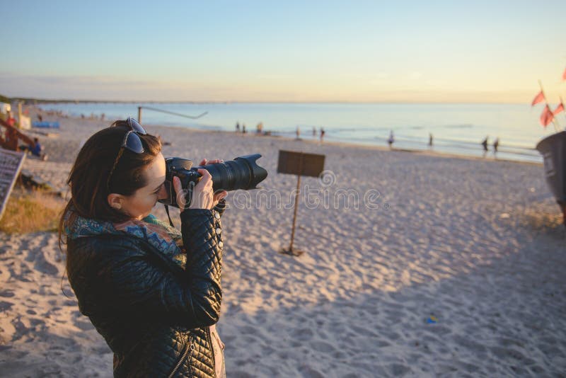 professional woman photographer on the beach