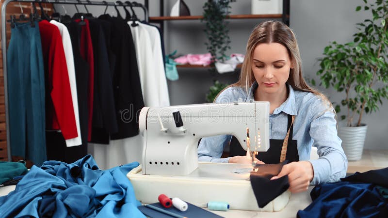 Confident Blonde Woman Dressmaker Sews Textile Handmade Clothes ...