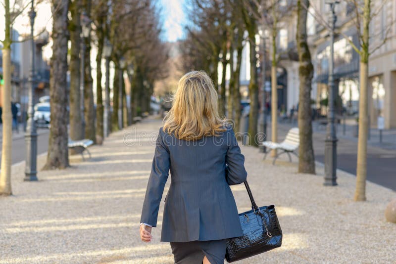 Professional woman walking away from the camera