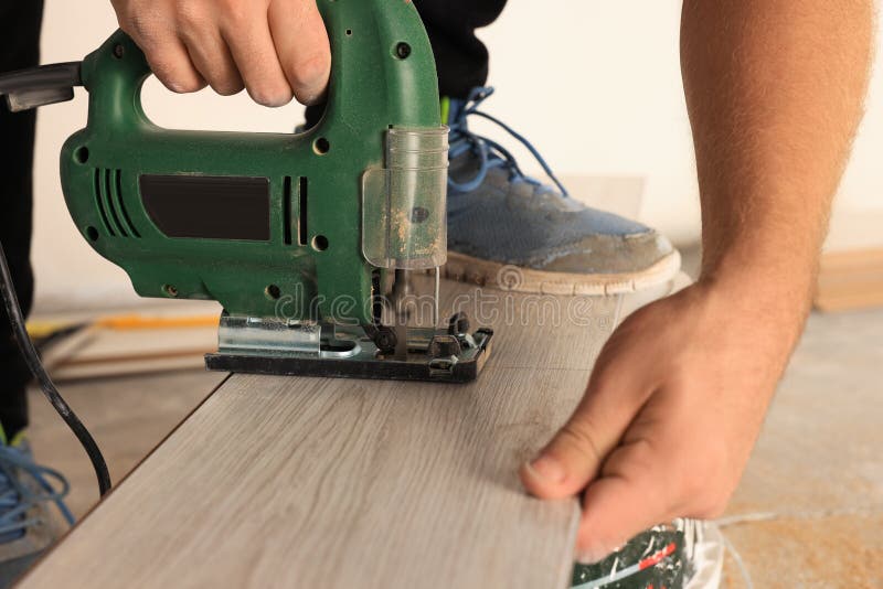 Man Using Jigsaw Blowing Sawdust from Wood Stock Photo Image of activity, equipment 258025602