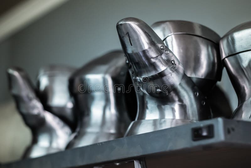 Professionally built metal gauntlets in a workshop. Close-up image of assembled and partially finished medieval armour suit royalty free stock images Professionally built metal gauntlets in a workshop. Close-up image of assembled and partially finished medieval armour suit royalty free stock images