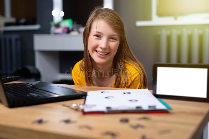 Caucasian teacher sitting in front of laptop. English alphabet on table for practical lessons. Distance learning. Home school education. E-learning perspective. Mock up tablet. High quality photo. Caucasian teacher sitting in front of laptop. English alphabet on table for practical lessons. Distance learning. Home school education. E-learning perspective. Mock up tablet. High quality photo