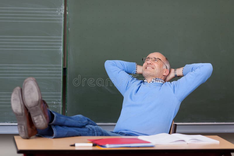 Professor With Hands Behind Head Looking Up At Desk stock images