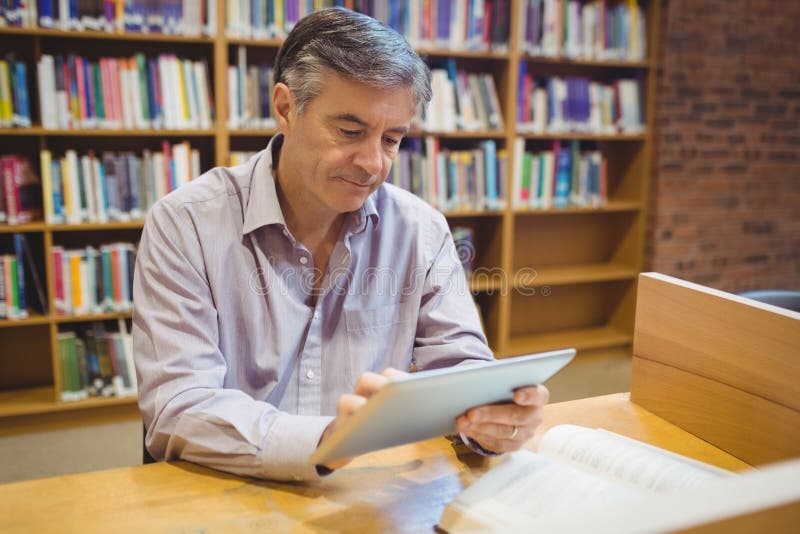 Professor Sitting at Desk Using His Laptop Stock Image Image of notes