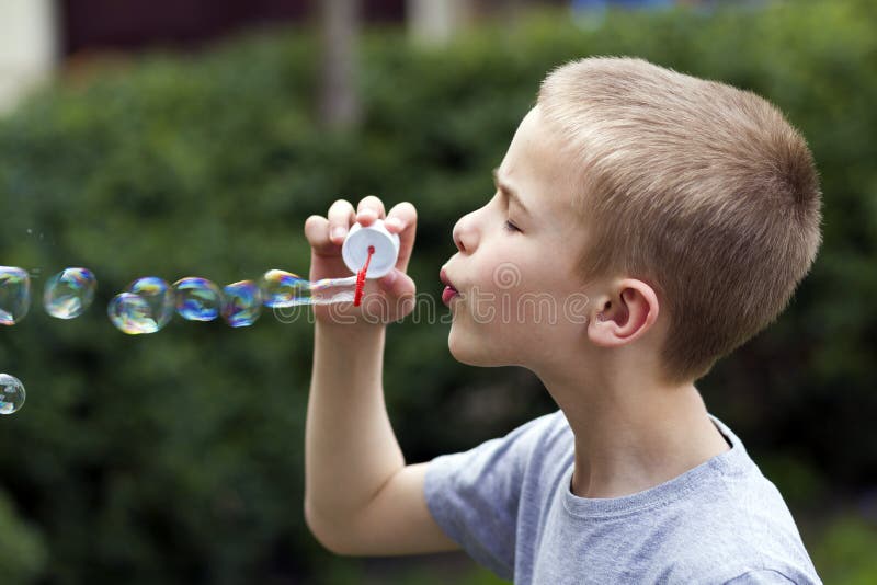 Profile of Cute Handsome Small Blond Child Boy with Funny Serious  Expression Blowing Colorful Transparent Soap Bubbles Outdoors O Stock Image  - Image of handsome, outside: 120222445