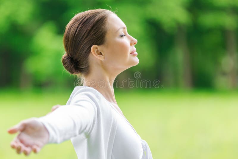 Profile of girl with outstretched arms and closed eyes