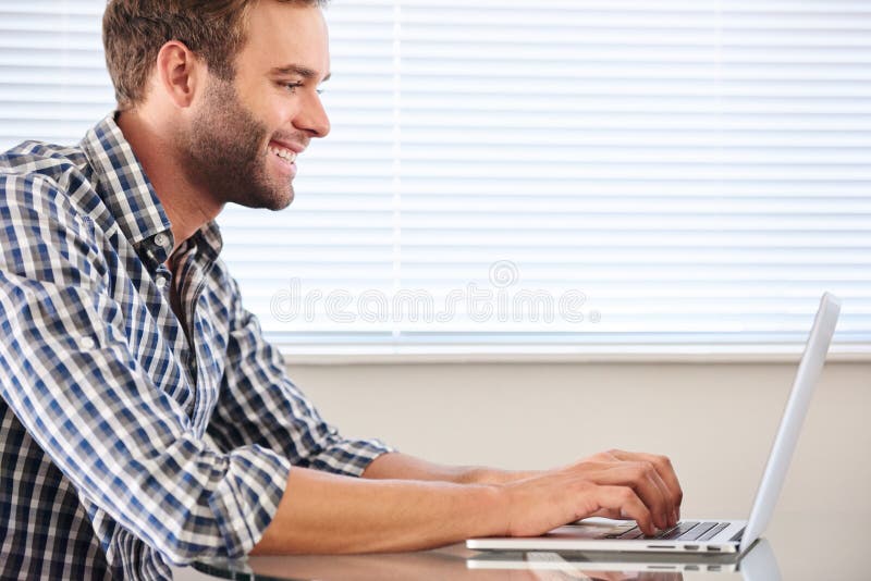 Profile image of handsome groomed man typing on laptop computer