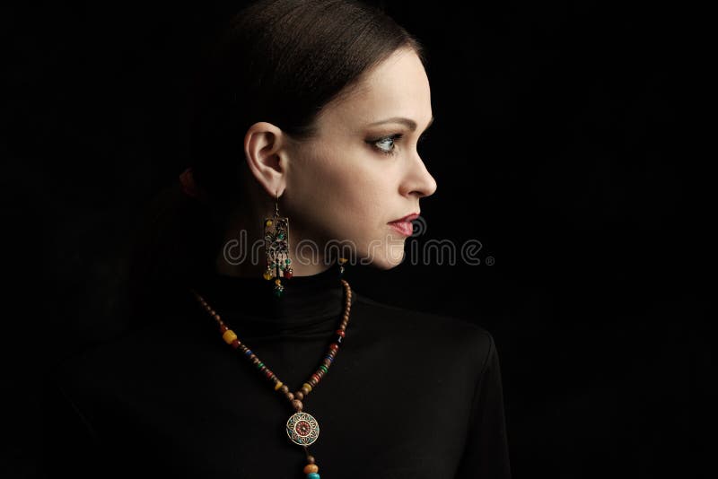 Profile portrait of a beautiful woman wearing ethnic jewelry