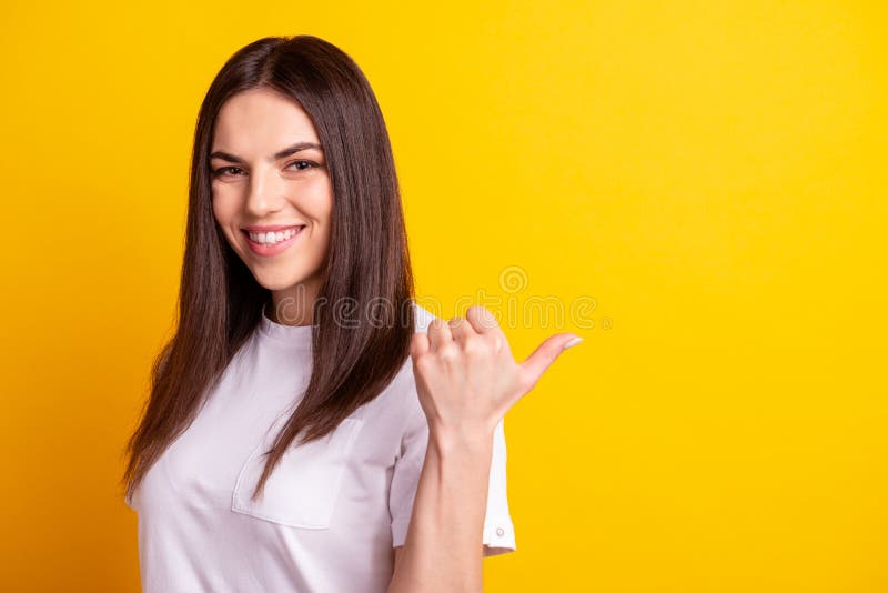 Profile side photo of young cheerful girl point thumb empty space advertising promo isolated over yellow color royalty free stock photo