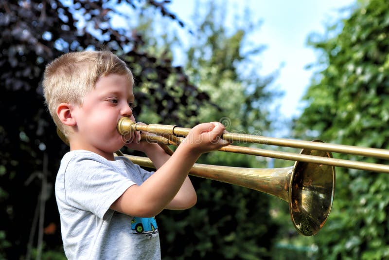 Profile of the Small Boy Trying To Play Trombone Stock Image Image of