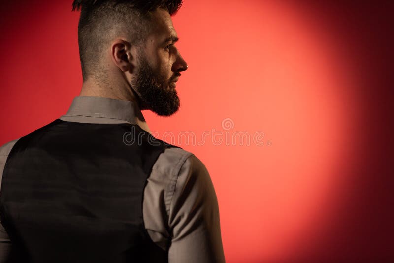 Profile of a Young Serious Bearded Man in a Black Vest on Red Background. Back  View Stock Image - Image of hair, dark: 165034113