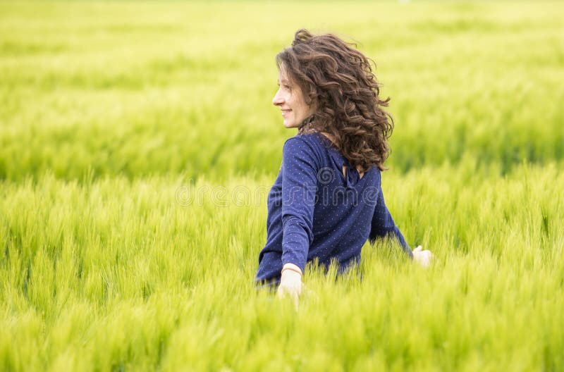Profile of young woman in wheat field