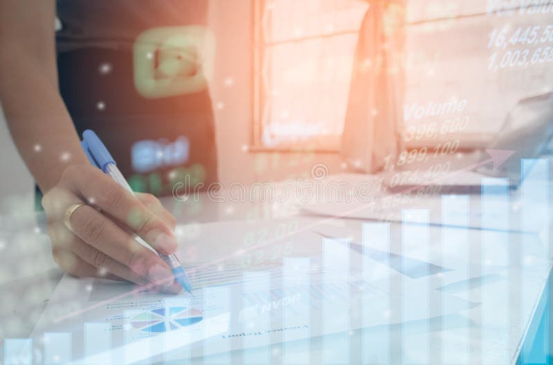 Profit graph of stock market indicator with hand touching tablet for check data or graph investment stock photo
