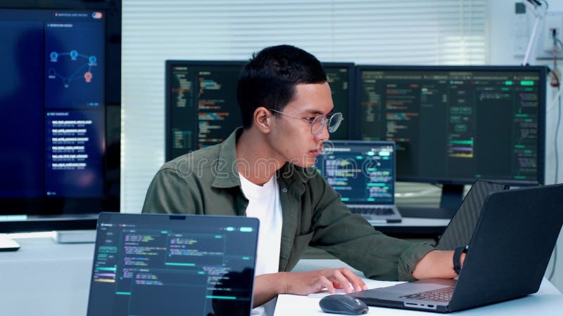 Programmer Coding Software Application on Multiple Screens stock video footage