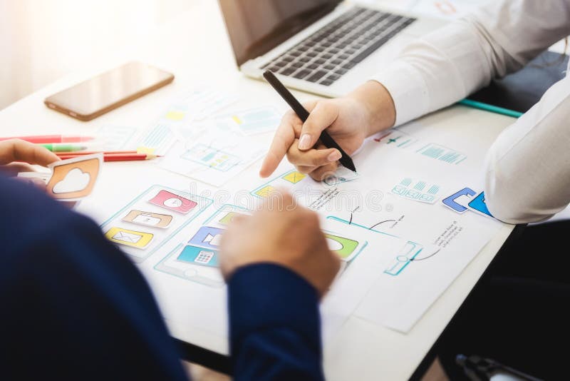 Programmer developing technologies about wireframe application design of mobile phone on the desk. User experience Design concept. Developing programmer stock images, royalty-free photos and pictures