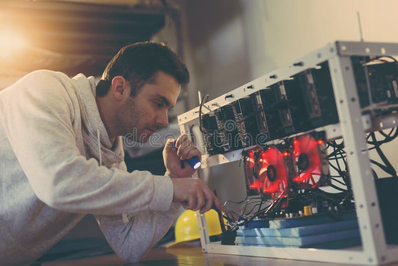 Programmer fixing the mining rig stock images