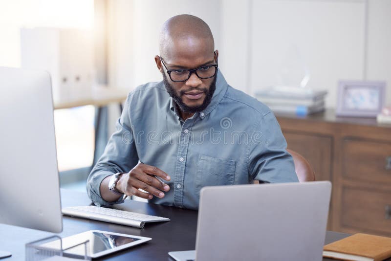 Programmer, laptop and black man reading software, coding or email in office. IT, computer and African professional stock photography