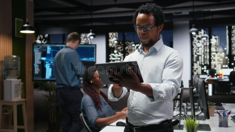 Programmer in office developing app using tablet, writing code stock video