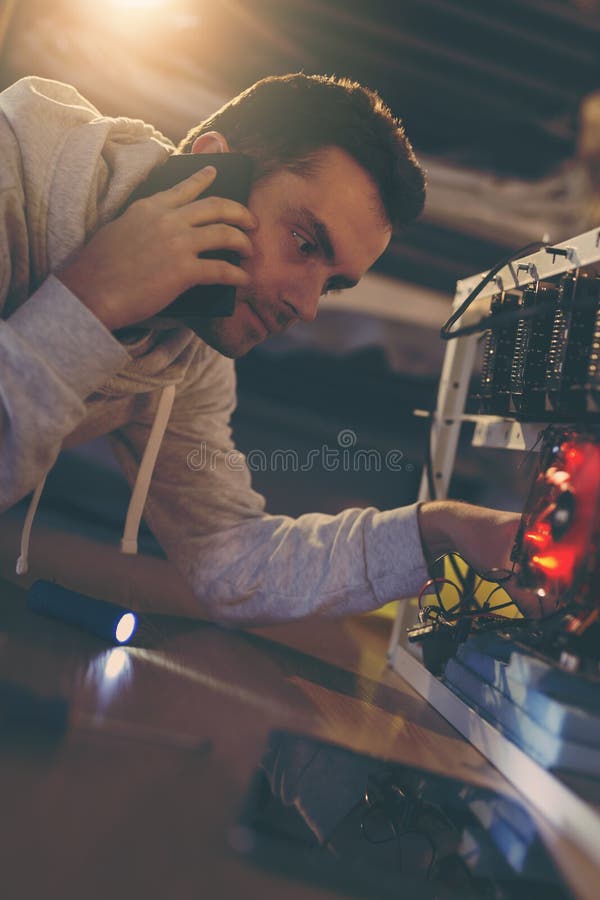 Programmer setting up a mining rig stock image