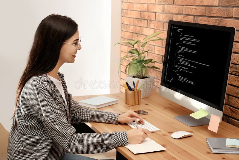 Programmer working with computer in office stock photography