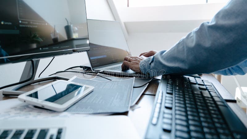 Programmer working On Computer In IT Office Typing Data Coding in software and checking code on computer screen. Program coding working stock images, royalty-free photos and pictures