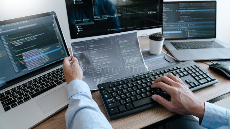 Programmer working On Computer In IT Office Typing Data Coding in software and checking code on computer screen. Program coding working stock images, royalty-free photos and pictures