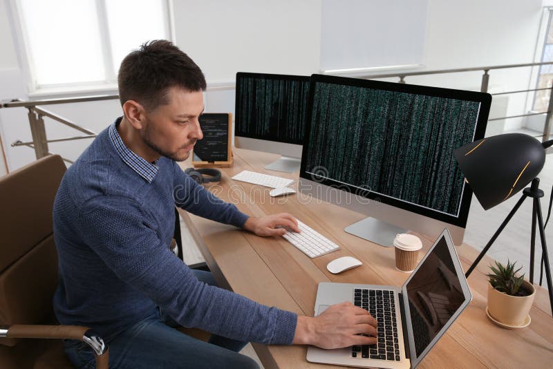 Programmer working at desk in office royalty free stock photos
