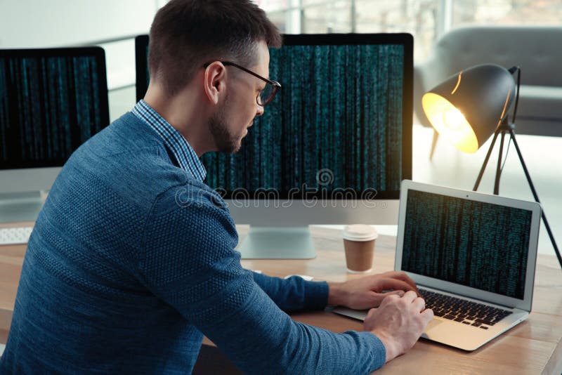 Programmer working at desk in office stock photos