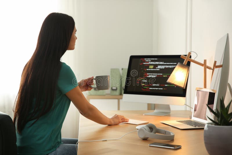 Programmer working at desk in office stock photography