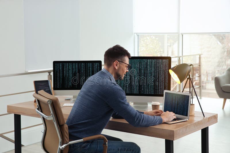 Programmer working at desk in office stock images