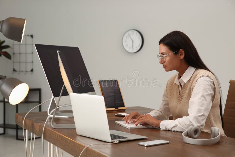 Programmer working at desk in modern office stock photography
