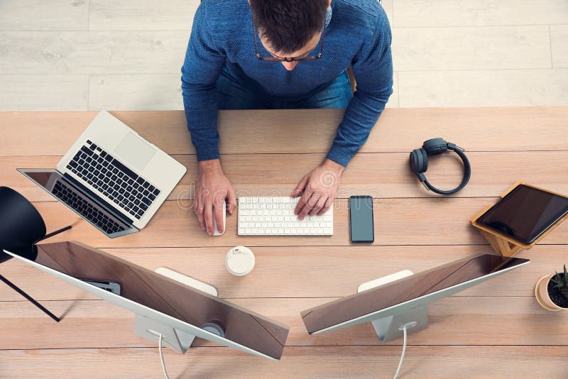 Programmer working at desk in office stock image