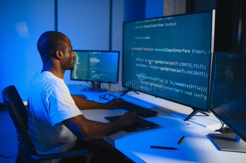 African american IT Programmer Working on Desktop Computer. stock images