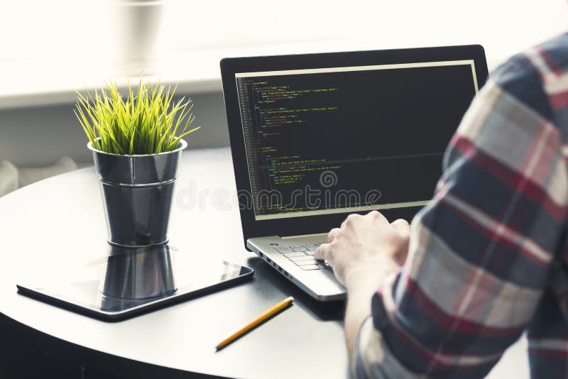 Programmer working on laptop at office royalty free stock images