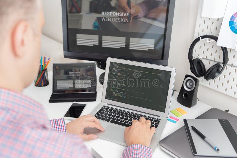 Programmer working on responsive website code royalty free stock photos