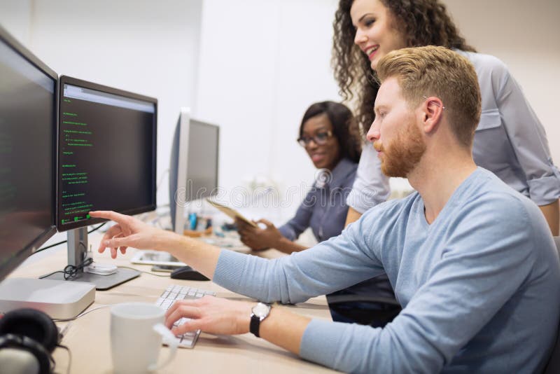 Programmer working in a software developing company office. Developing programmer stock images, royalty-free photos and pictures